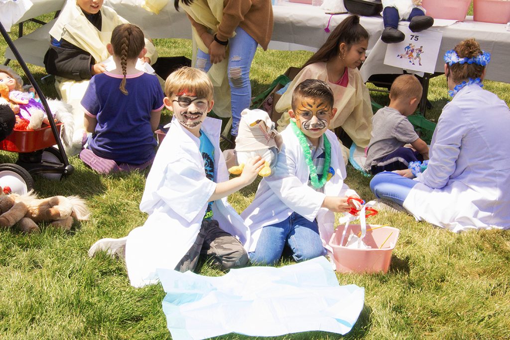Two kids with face paint pretending to be doctors in Gem County.