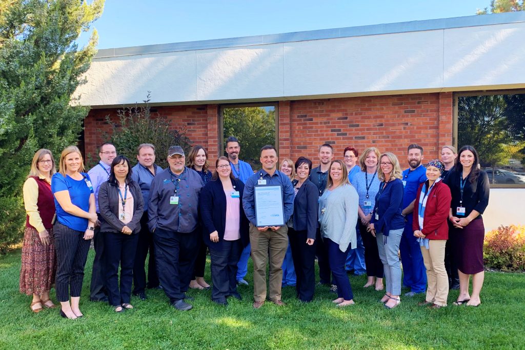 Valor Health staff displaying an award for providing safe, high quality, and patient-centered care. 