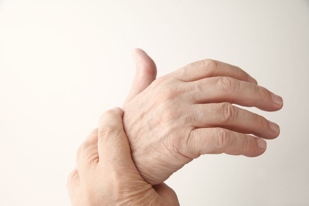 Person holding hand with arthritis